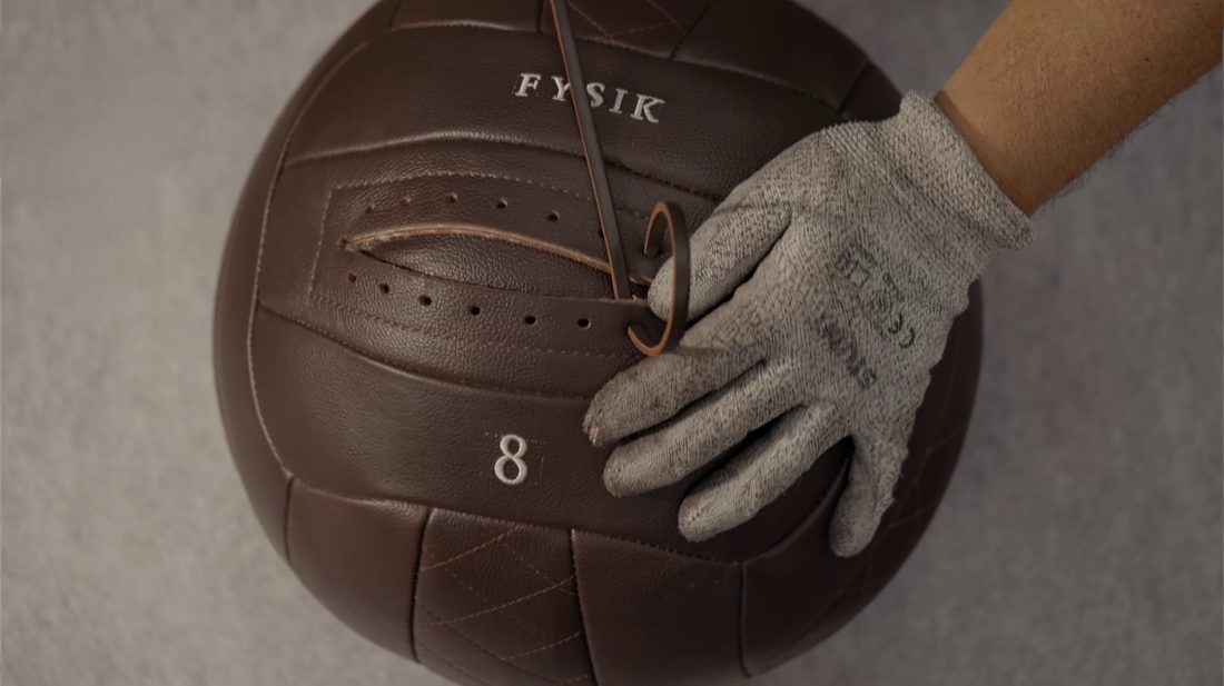 A leather medicine ball being hand-laced
