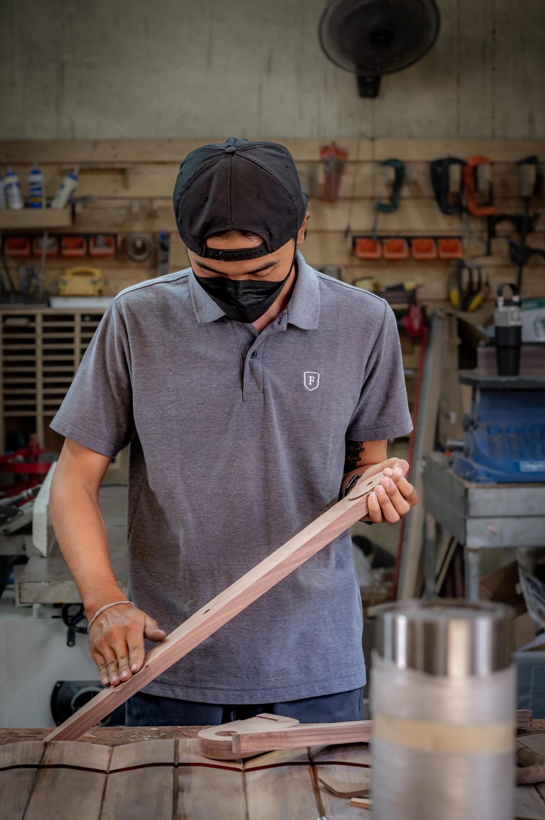 A craftsman shaping solid wood in the Bangkok workshop